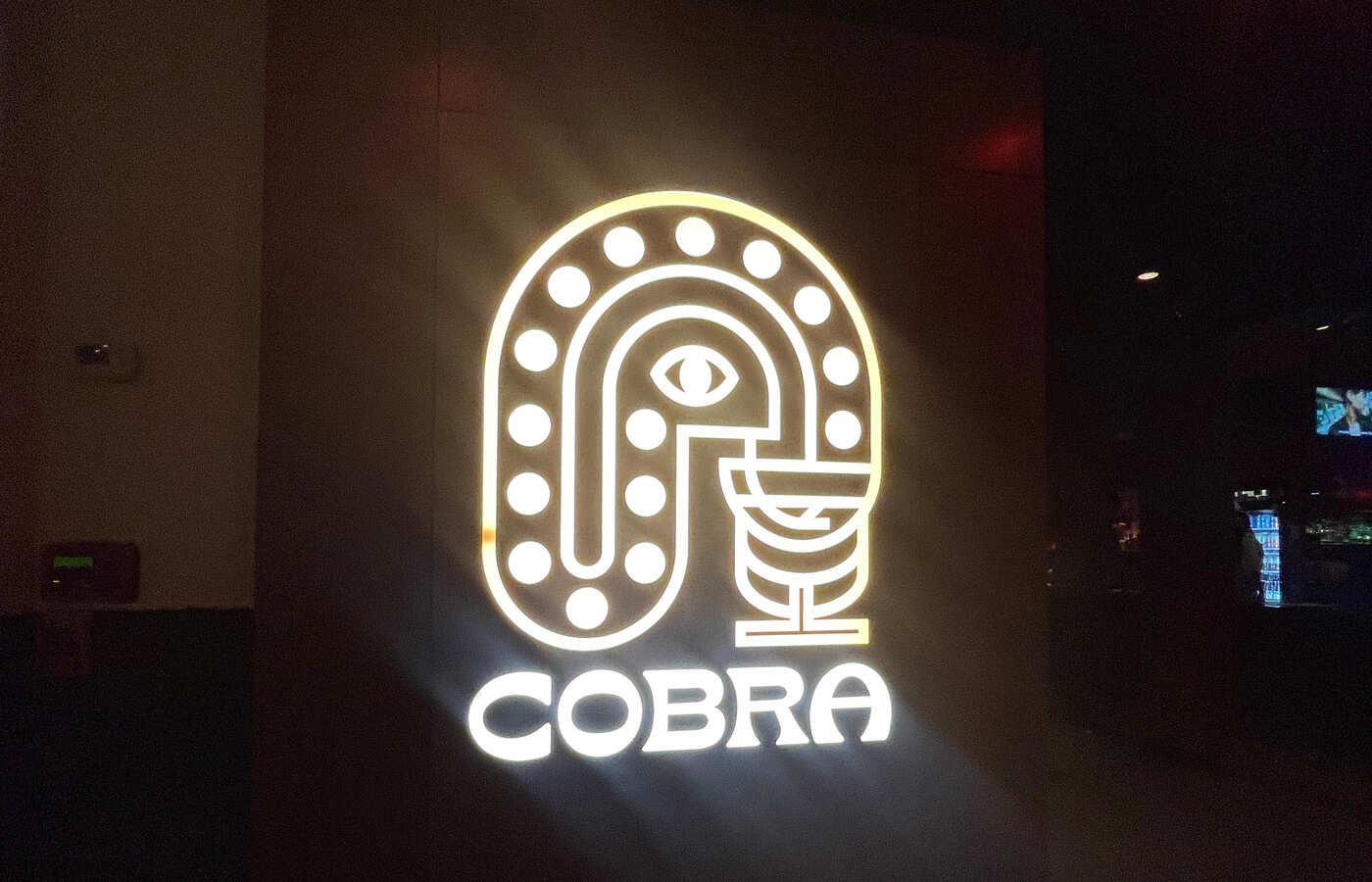 glowing sign at cobra bar
