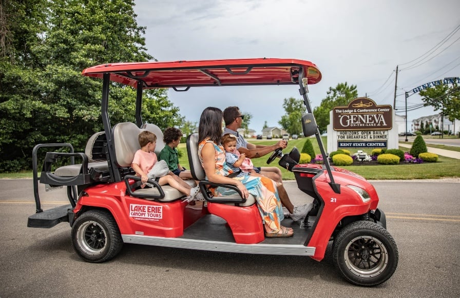 family on golf cart