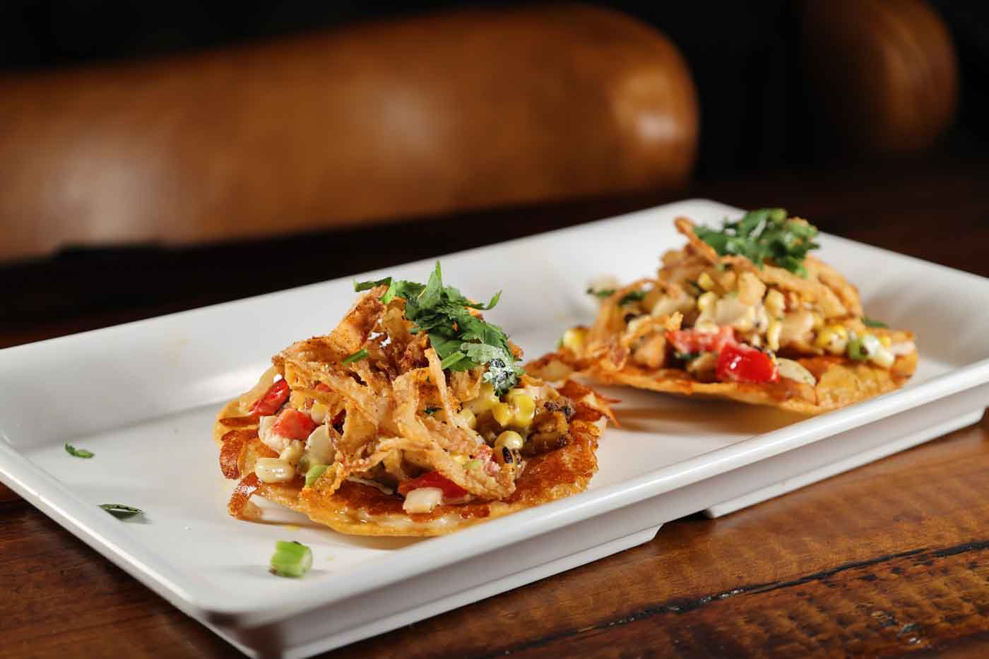 Grandview’s New Racing Simulator Bar Lets You Race F1 Cars And IndyCars 2 tacos on plate
