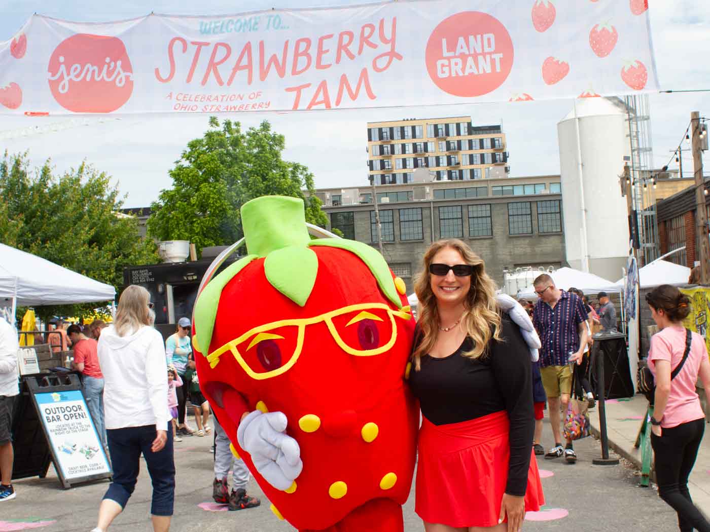person standing with strawberry mascot