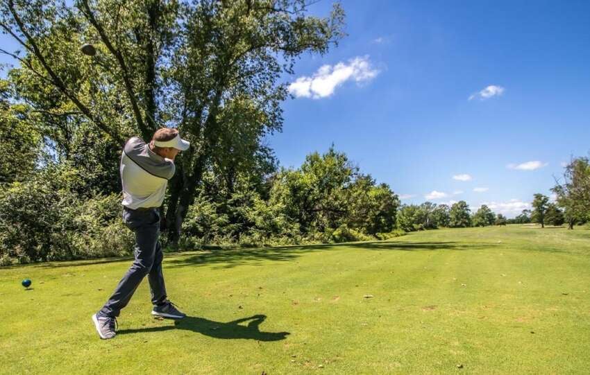 Man mid swing at Hueston Woods Golf Course