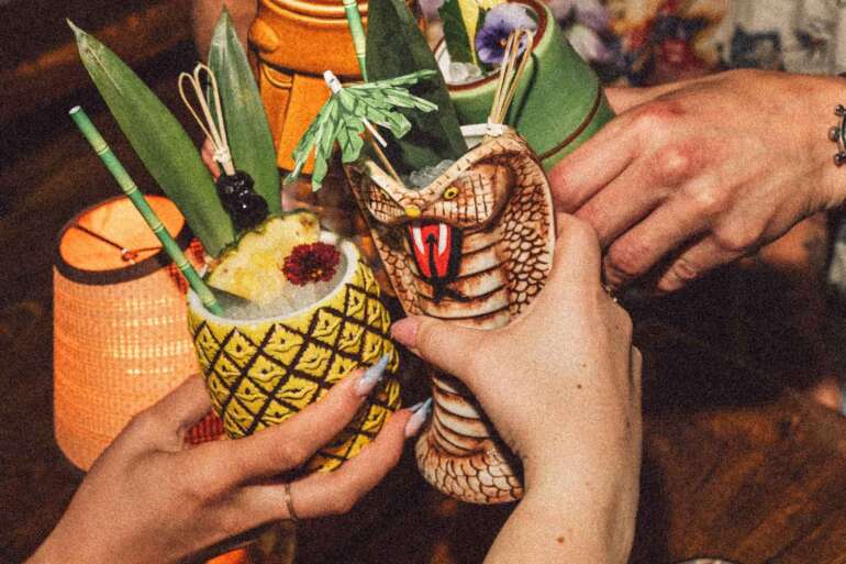 Columbus' Most Legendary Restaurant Is Inspiring A Brand-New Tiki Experience 3 tropical cocktails in tiki themed glasses