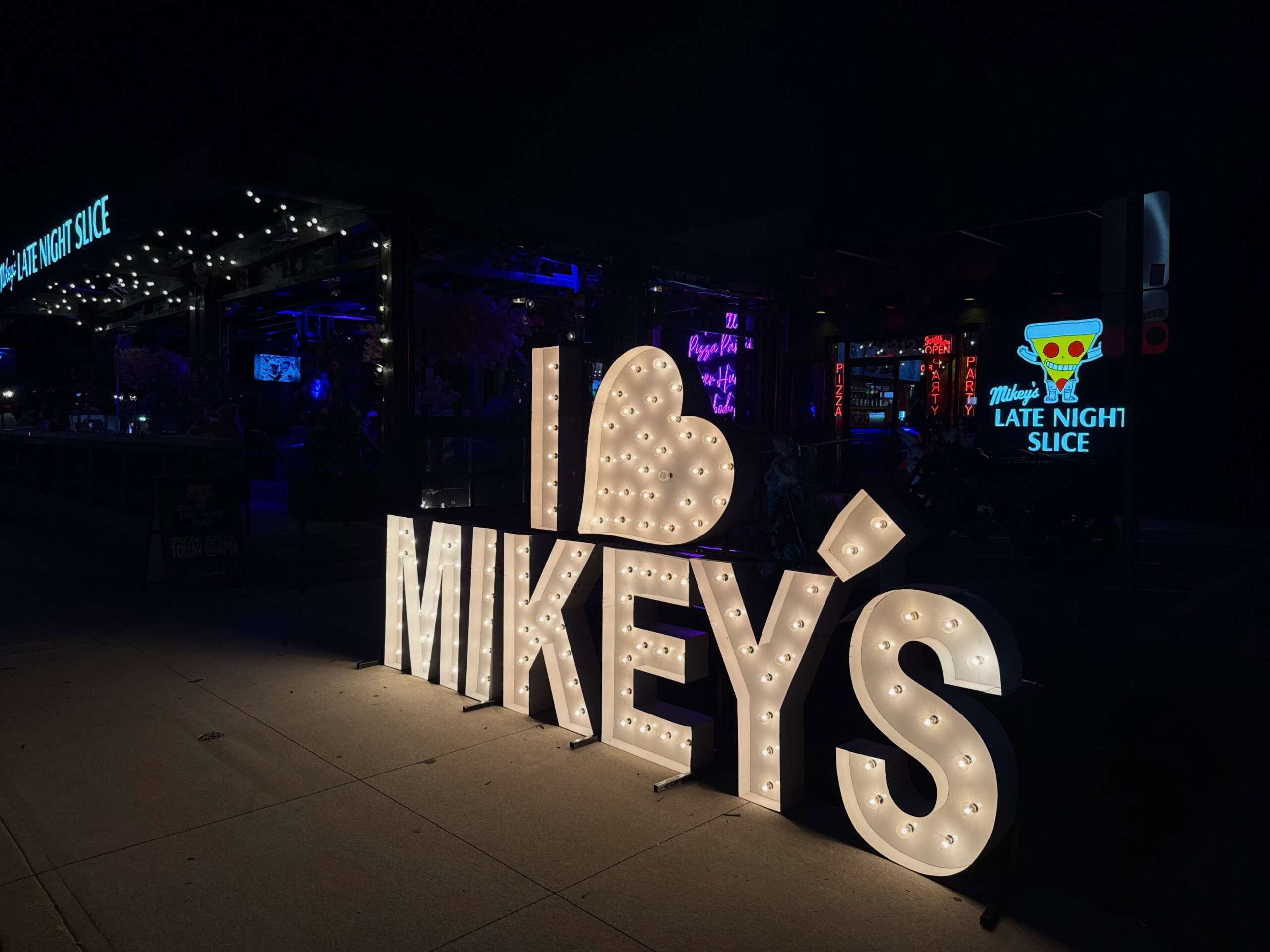 The Best New Restaurants In Columbus (August 2026) 10 illuminated sign that reads i heart mikey's.