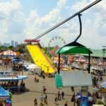 The Best Things To Do In Columbus This Weekend (August 7–9) The Ohio State Fair midway, giant slide, and Ferris wheel seen from the SkyGlider, with the downtown Columbus skyline in the distance