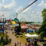 The Best Things To Do In Columbus This Month (August 2026) The Ohio State Fair Ferris wheel, giant slide, and midway rides seen from the SkyGlider over the fairgrounds