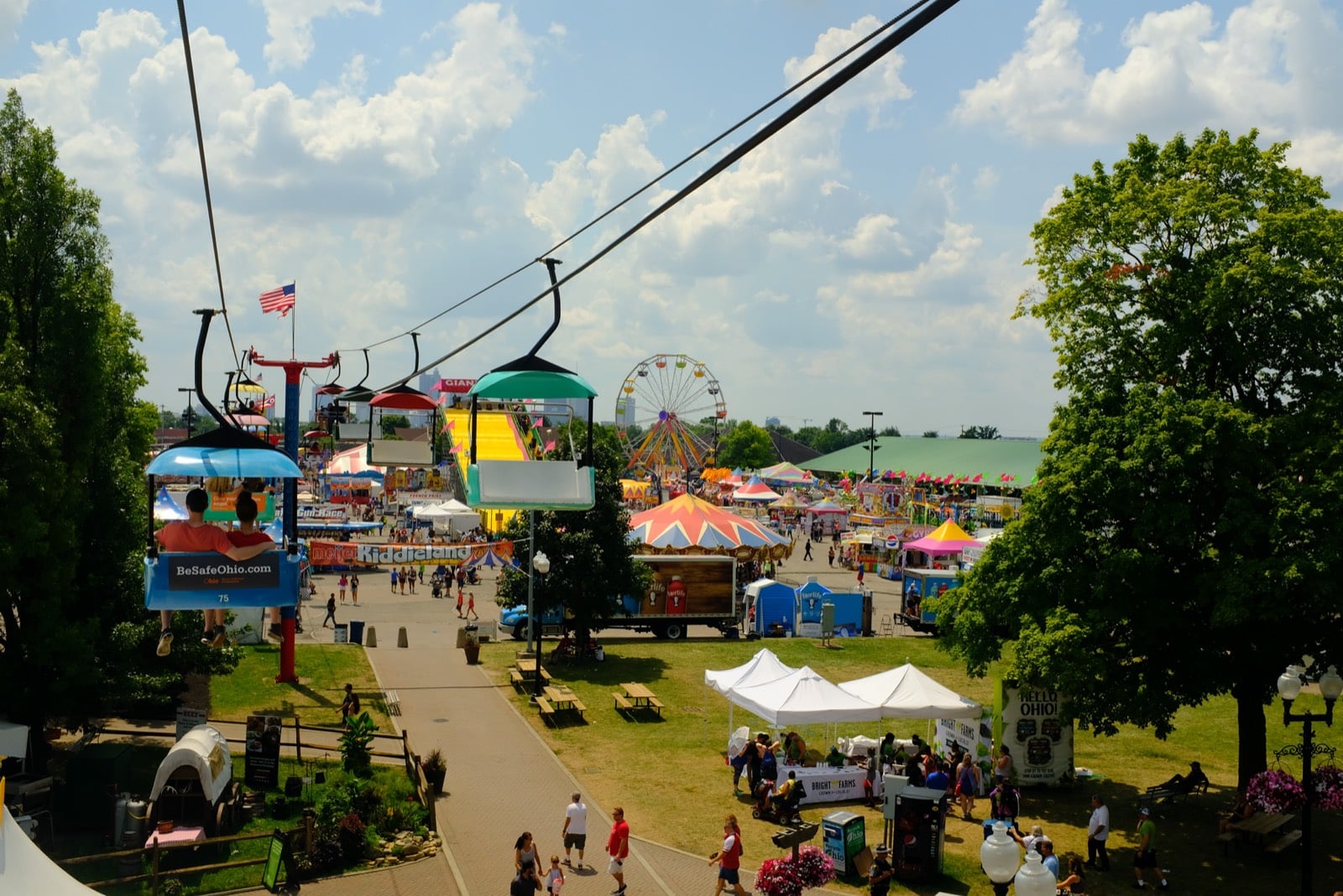 The Ohio State Fair Ferris wheel, giant slide, and midway rides seen from the SkyGlider over the fairgrounds