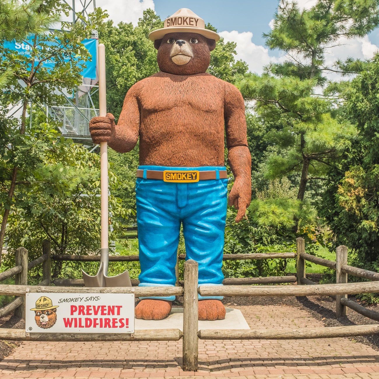 The tall Smokey Bear statue holding a shovel at the Ohio State Fair Natural Resources Park, beside a Smokey Says Prevent Wildfires sign