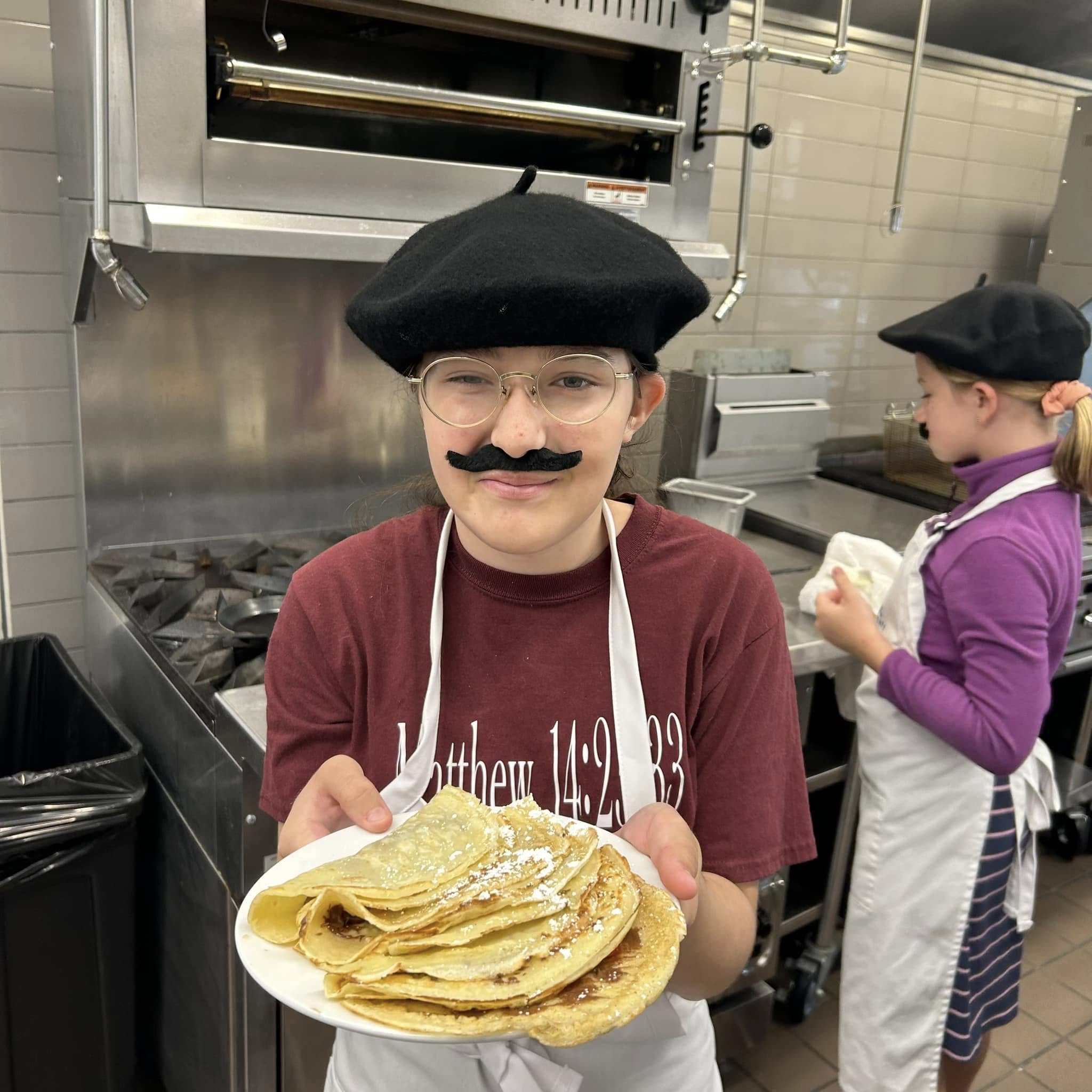 Kids Cooking Classes In Columbus: 6 Spots For Young Chefs 6 child in beret with fake moustache holding food