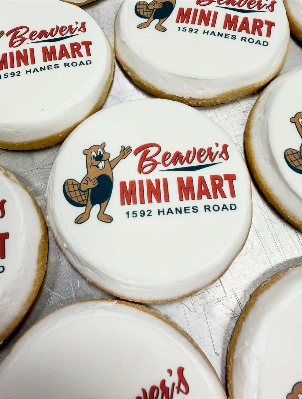 sugar cookie featuring a smiling beaver logo for beavers mini mart