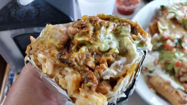 Here Are The Best Burritos In Columbus And Some Are As Big As Your Head 3 A Mission style burrito cut open to show rice, beans and meat