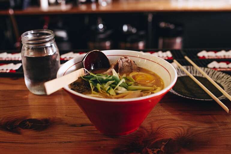 Bowl of pho on a restaurant table