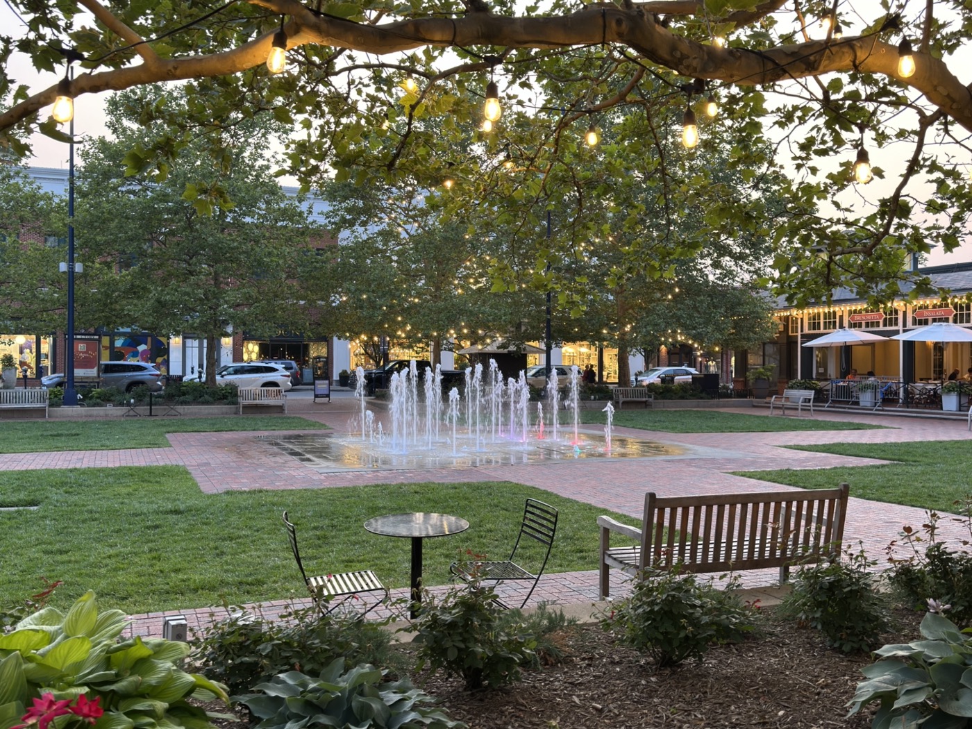 Fountain and string lights in the town square at Easton Town Center at dusk