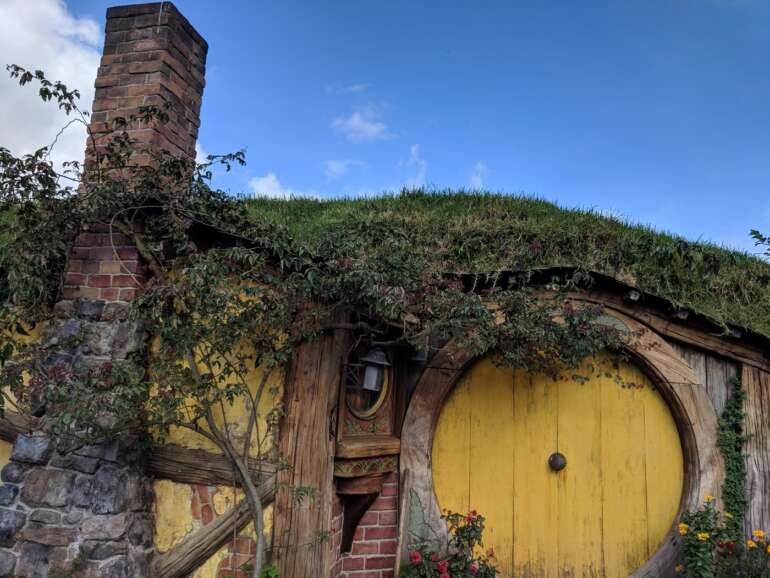 Waynesville’s Lord of the Rings Festival Brings Middle-Earth To Ohio 6 Round yellow hobbit door with grass roof at the Hobbiton movie set in New Zealand