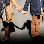 Two people holding hands