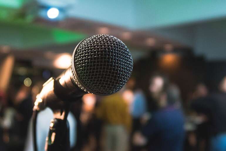 The Most Ridiculous Karaoke Nights Columbus Has To Offer 13 Microphone at a karaoke night with a crowd in the background