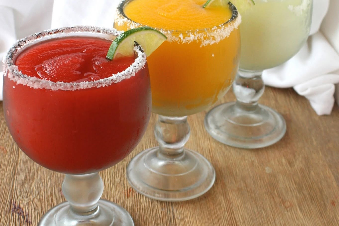 three blended margaritas with salted rims
