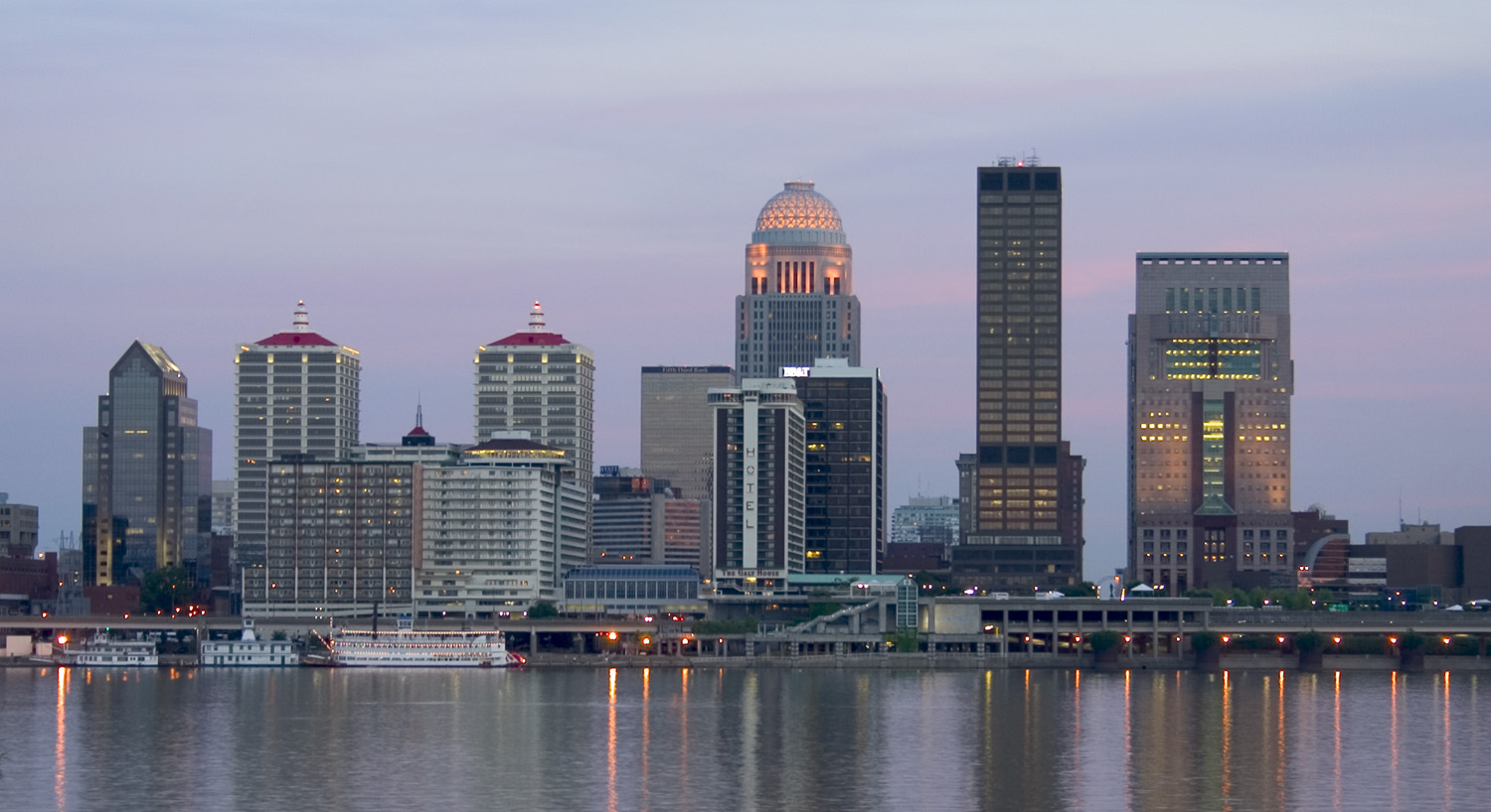 Louisville skyline along the Ohio River at dusk