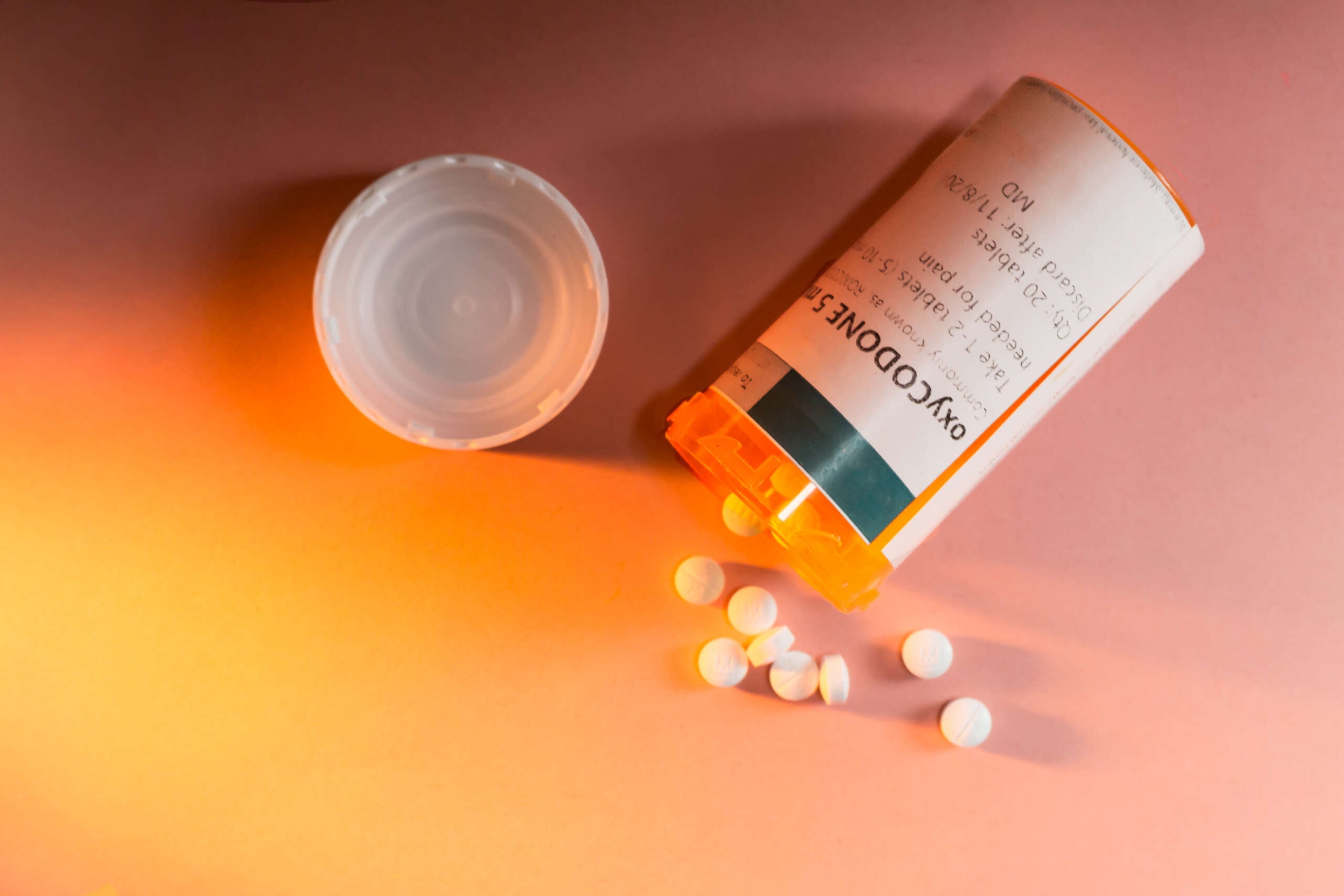 A prescription bottle with pills spilling out