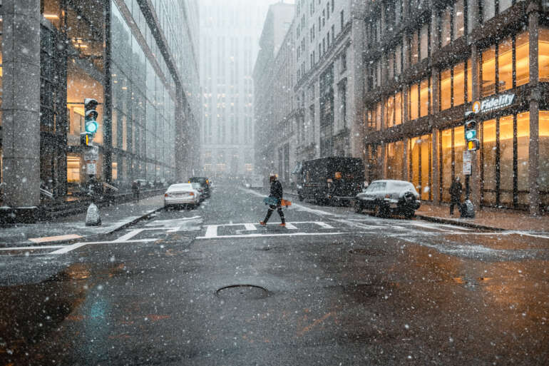 Snow falling on a downtown street