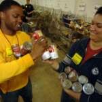 Volunteers sorting canned goods at a food bank