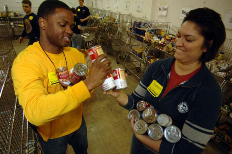 50 Ways To Volunteer In Columbus 7 Volunteers sorting canned goods at a food bank