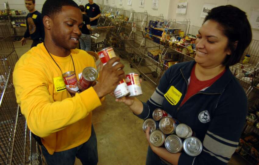 Volunteers sorting canned goods at a food bank