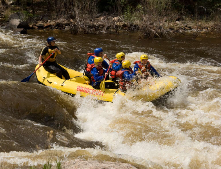 Raft going through whitewater rapids