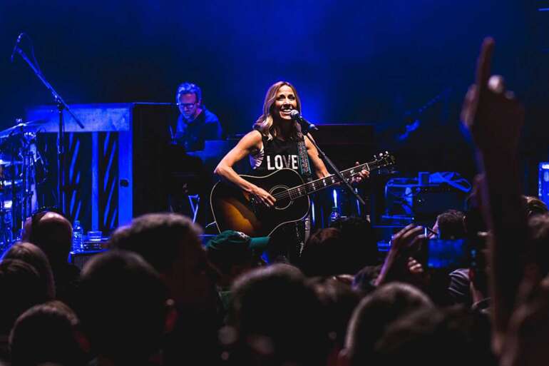 sheryl crow playing guitar on stage