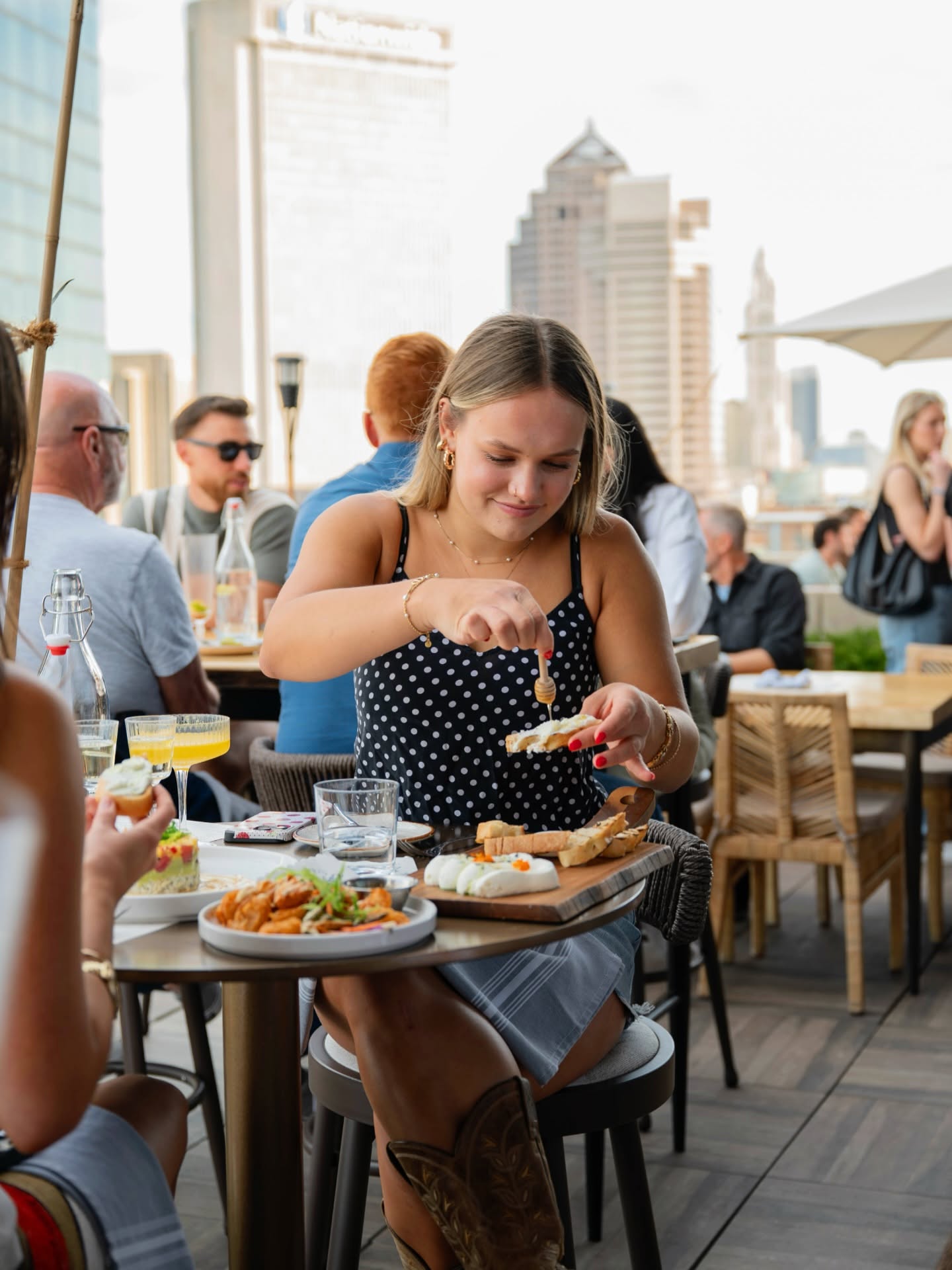 woman holding food on rooftop patio
