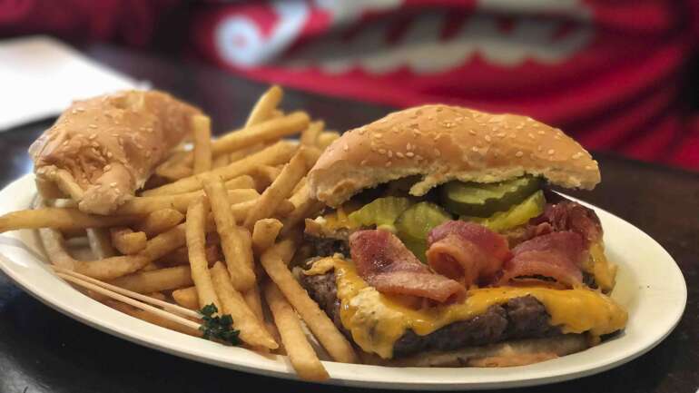 Bacon cheeseburger with pickles and fries at Johnnie's Tavern