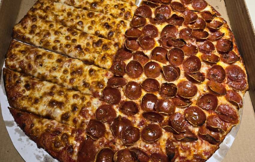 Half cheese, half pepperoni Columbus-style pizza from Massey's, cut into rectangles, in a delivery box