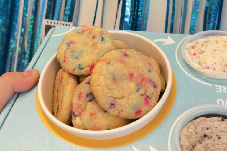 Lion Cub’s Cookies Just Brought Back A Very ’90s Way To Eat Cookies 4 cookies on tray with cups of icing