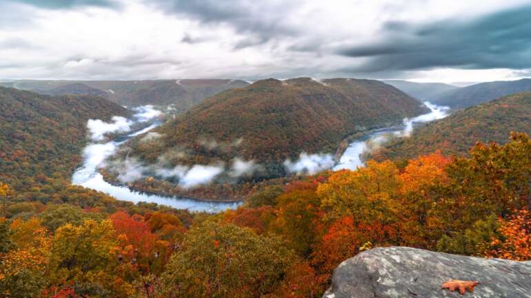 12 Magical Fall Getaways You Can Reach in 4 Hours or So from Columbus 21 The New River bending around a forested ridge in peak fall color with mist on the water, seen from Grandview