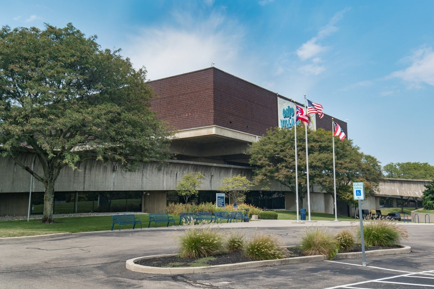 The Ohio History Center museum building and flagpoles seen from its empty front plaza