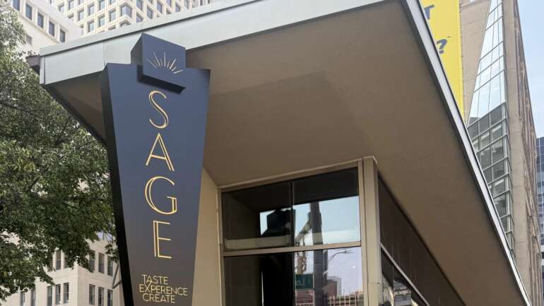 The Best New Restaurants In Columbus (October 2026) 2 The SAGE restaurant sign and glass storefront on North Third Street in downtown Columbus