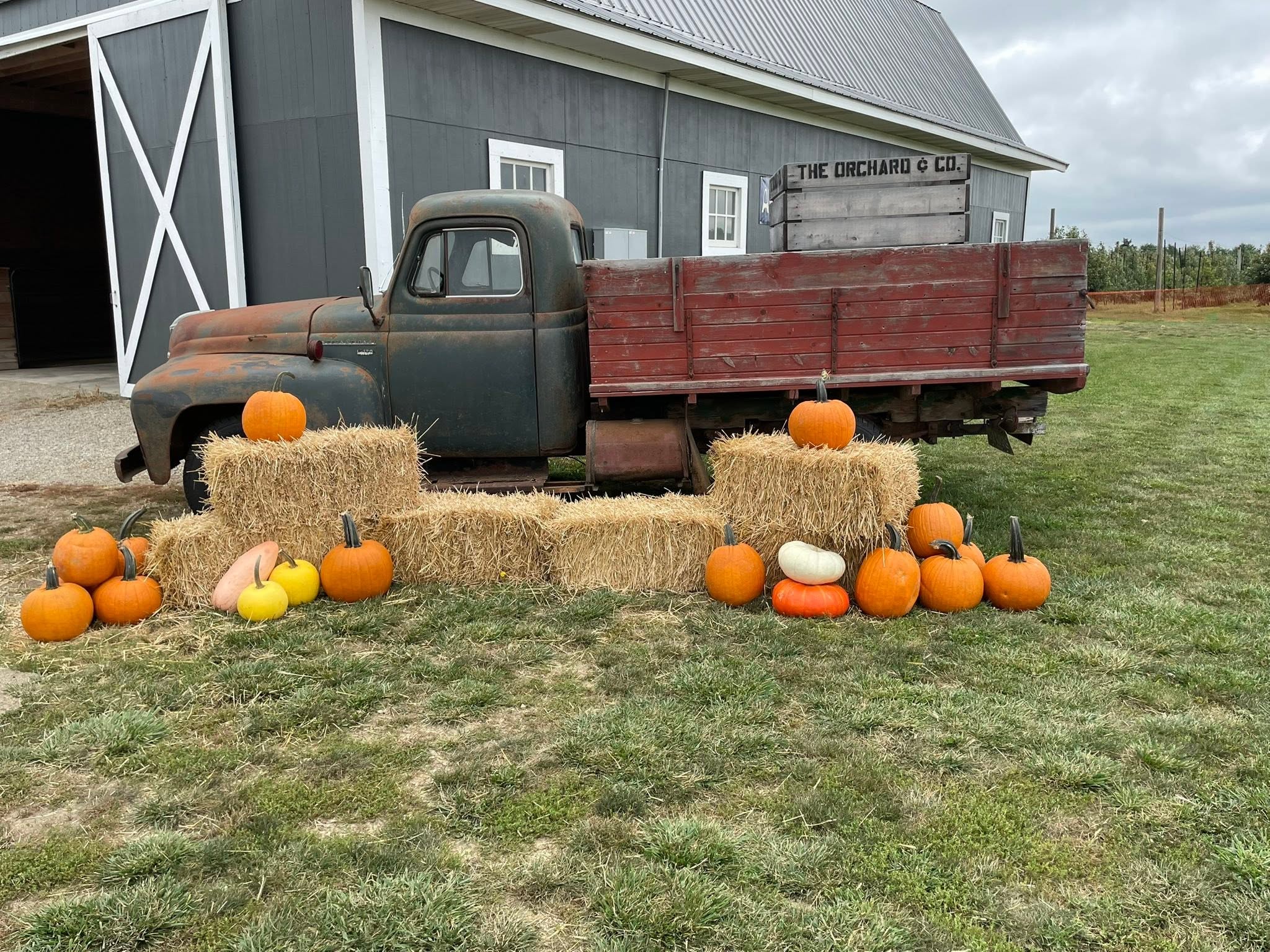 13 Perfect Pumpkin Patches To Check Out Around Columbus 13 pupmkins and hay bales in front of old red truck