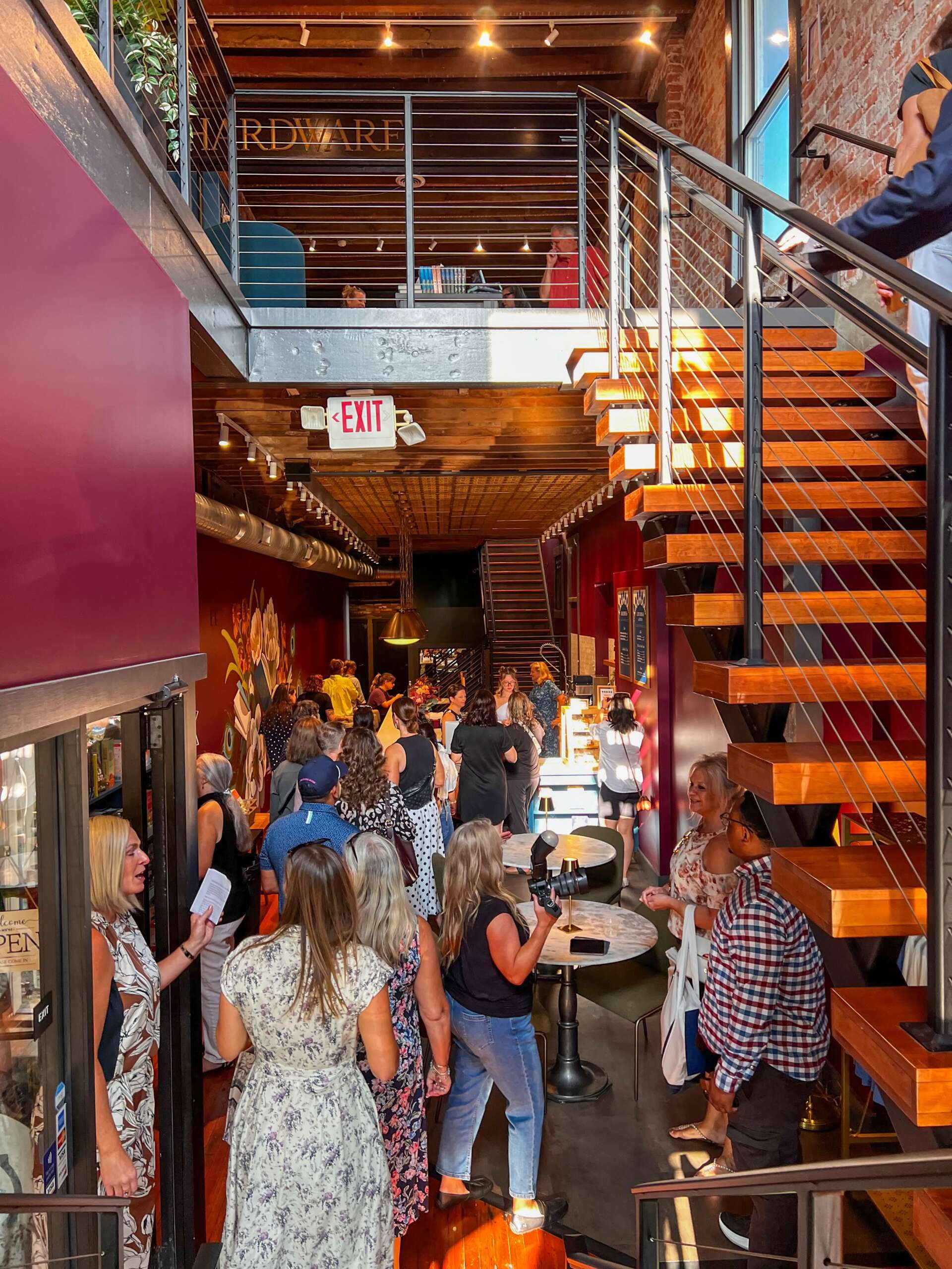The Best New Restaurants In Columbus (October 2026) 2 people gathered in bar with book store above