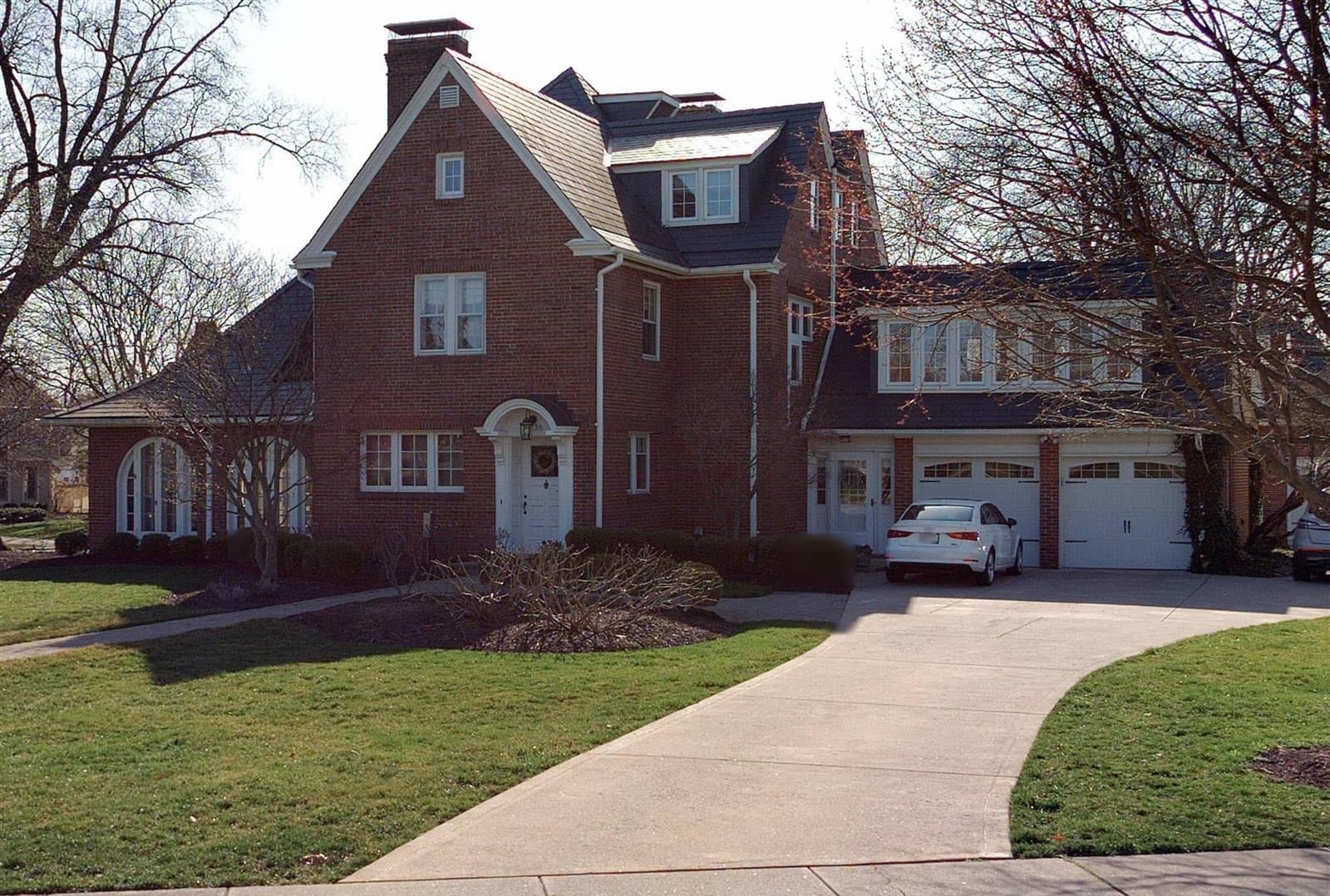 brick tudor style house with a steep gable and arched entry upper arlington ohio