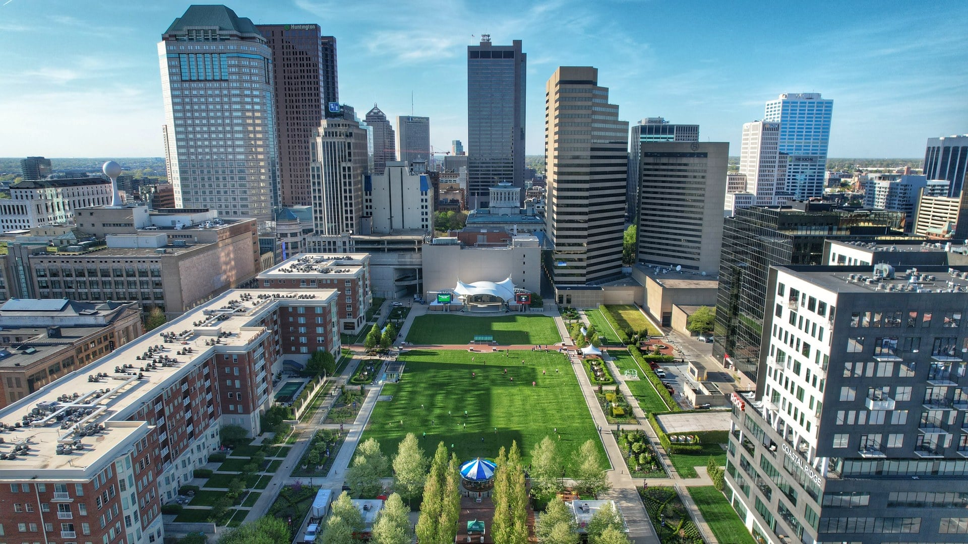 The Best Things To Do In Columbus This Weekend (October 23–25) 6 Aerial view of the Columbus Commons lawn, carousel and pavilion with the downtown Columbus skyline beyond