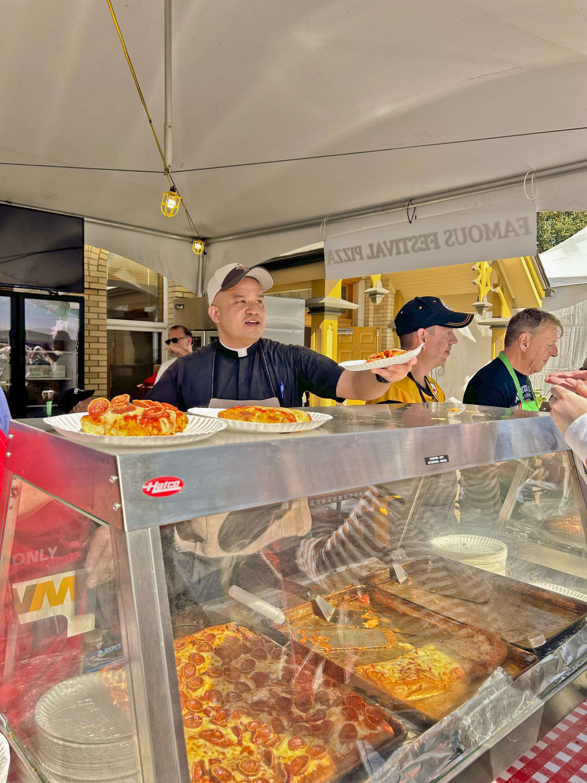man serving pizza
