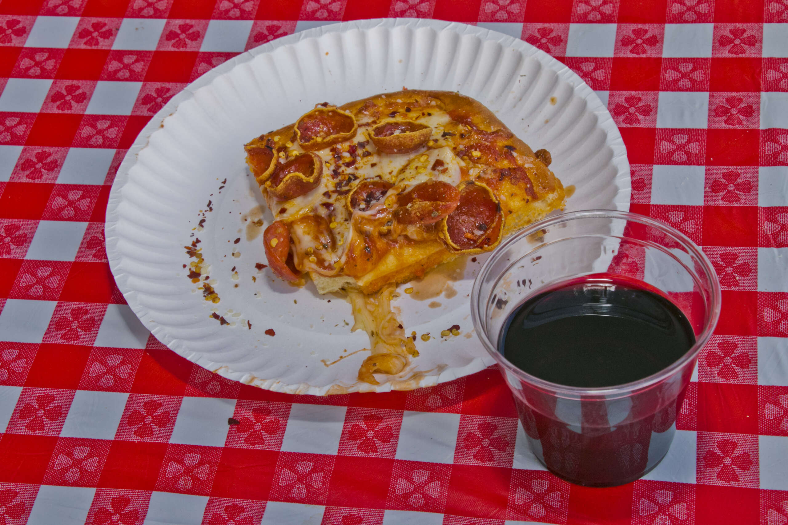sicilian style pizza on plate with glass of wine