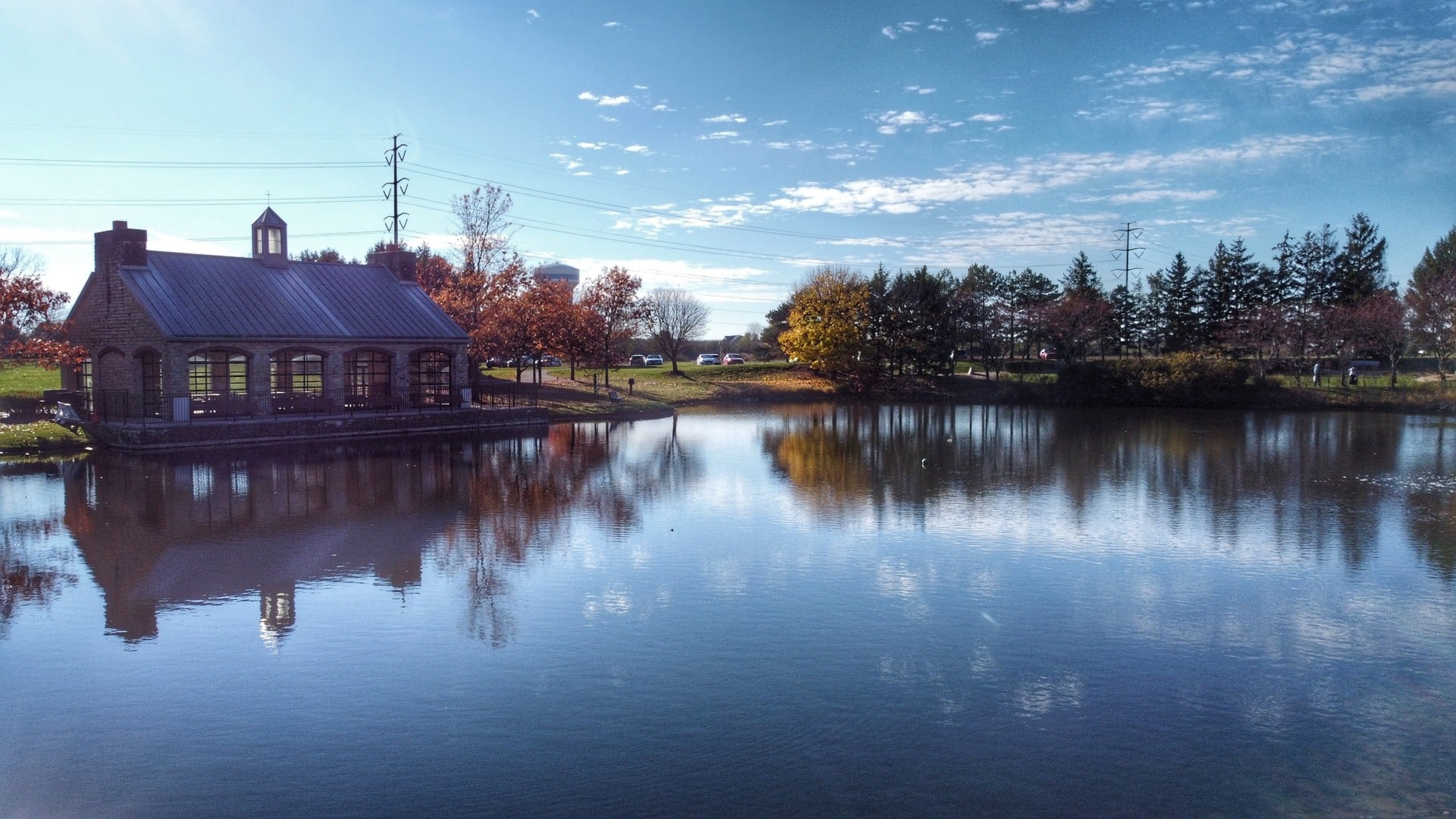 The Best Things To Do In Columbus This Weekend (October 23–25) 7 A stone-and-timber shelter on the edge of the pond at Homestead Metro Park, with fall color reflected in the water