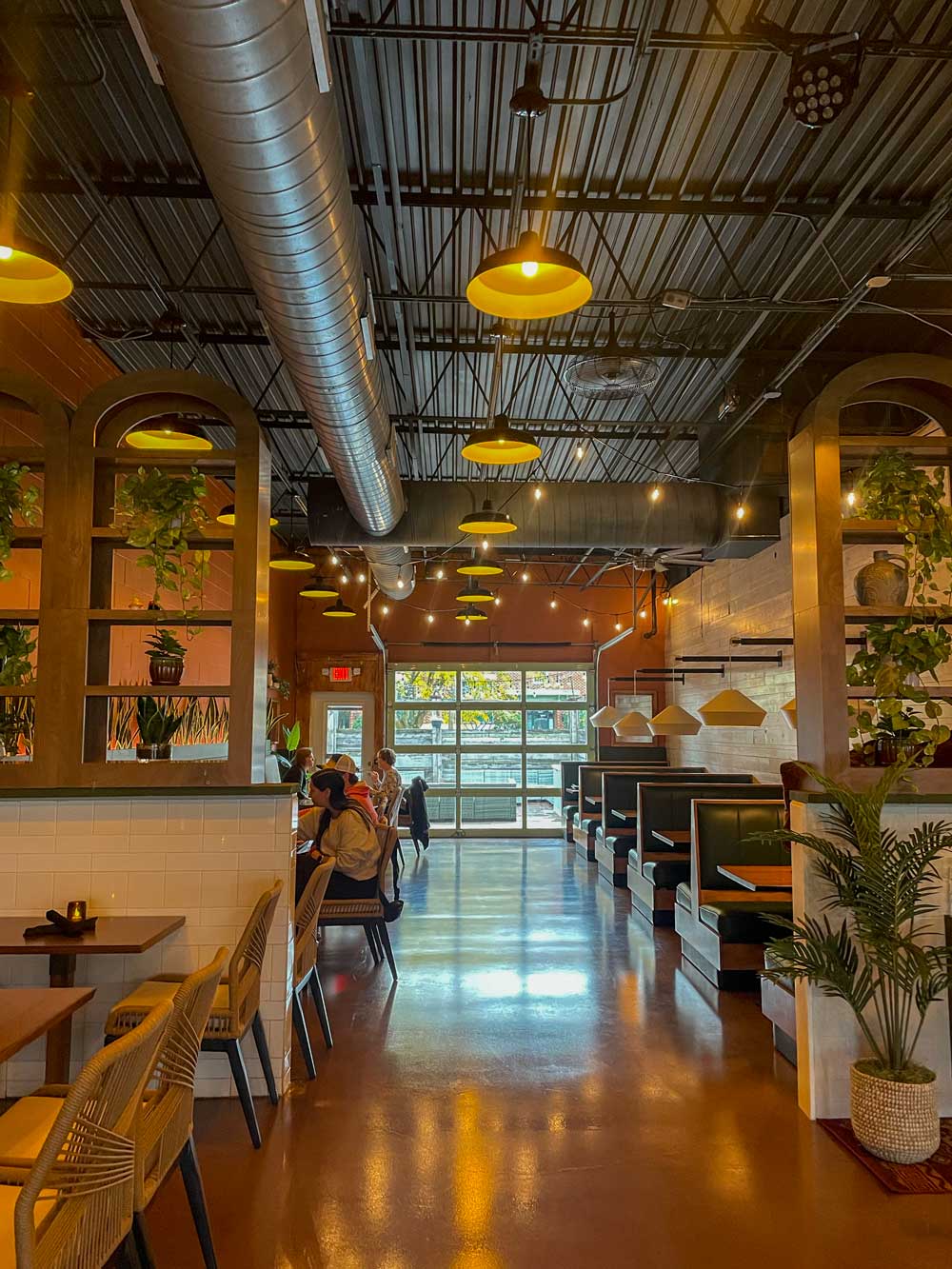Ochoa Mexican Grill Brings Tacos And Cocktails To East Main Street 6 interior of restaurant with tables and large garage-door style window