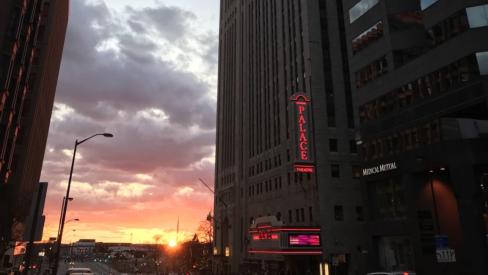 The Best Things To Do In Columbus This Month (October 2026) 8 The Palace Theatre sign and marquee lit in red neon at sunset on West Broad Street